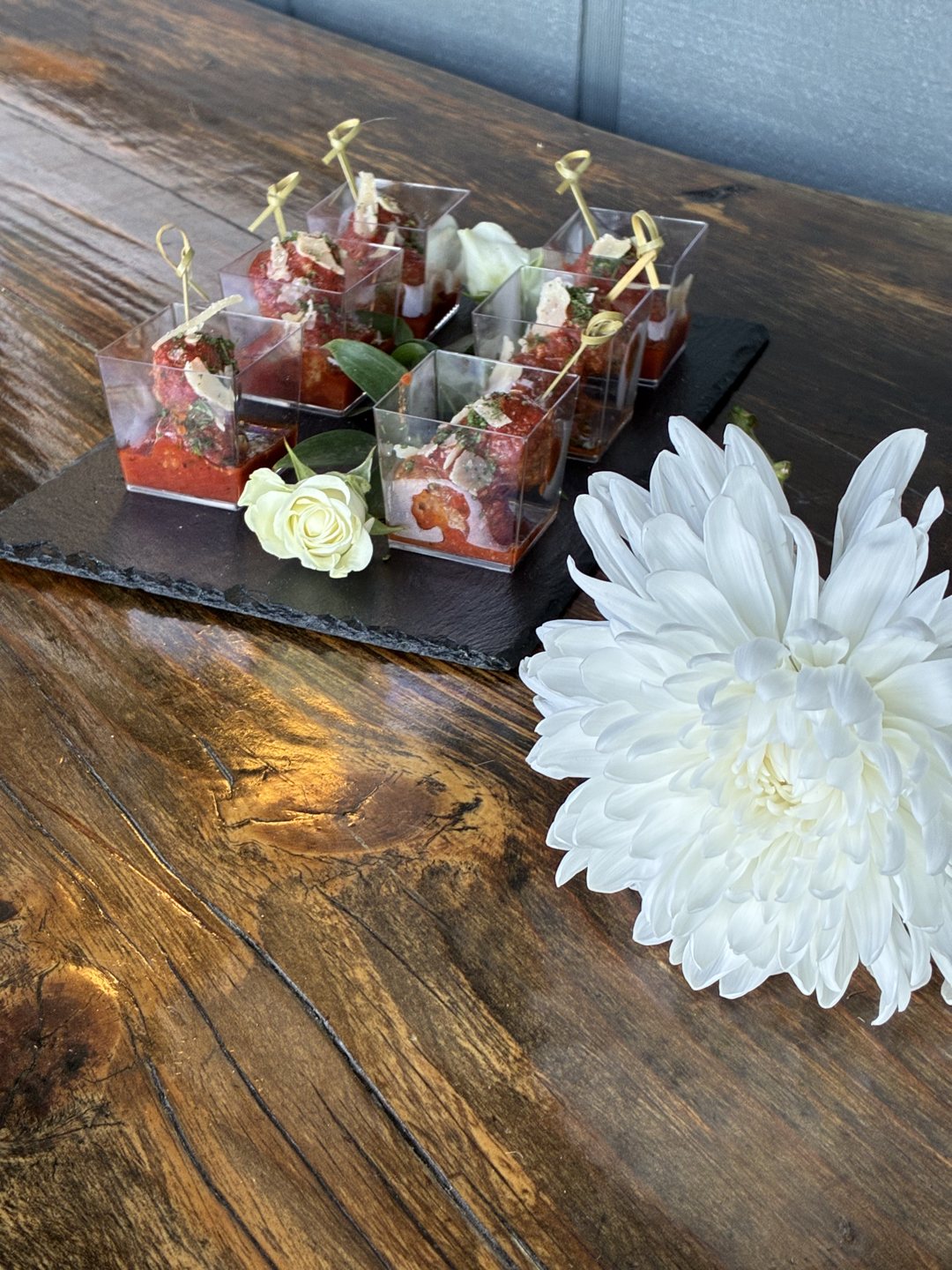 Individual dessert shooters finished with a floral detail