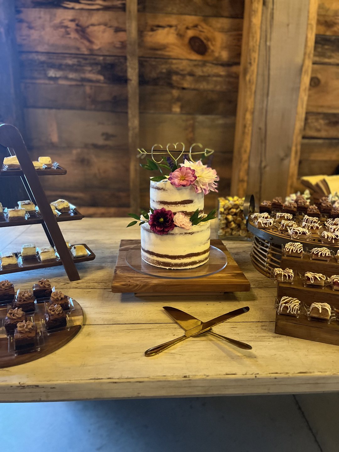 Wedding dessert display with a floral-accented cake