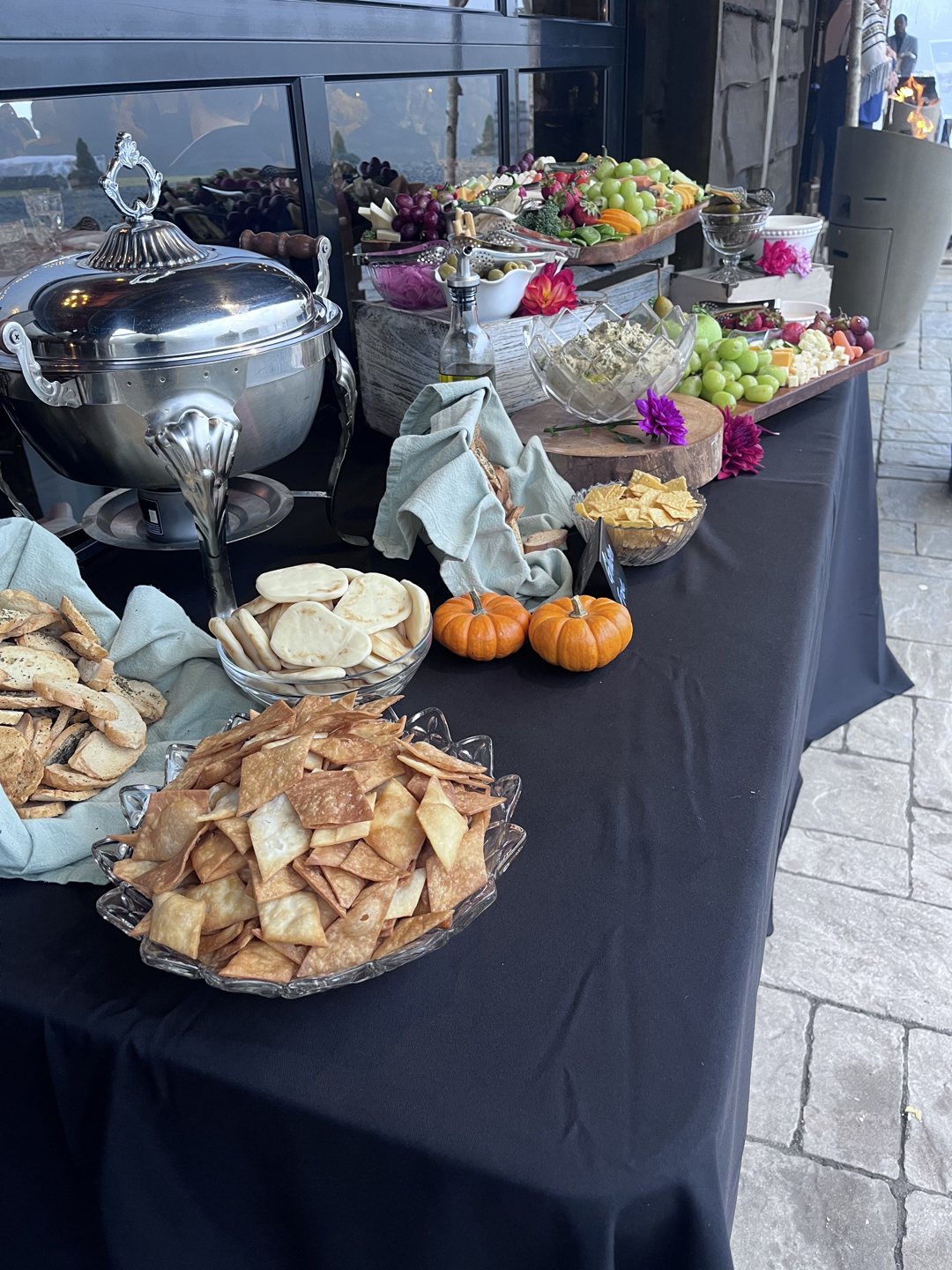 Generous grazing table with fresh breads, fruit, and appetizers